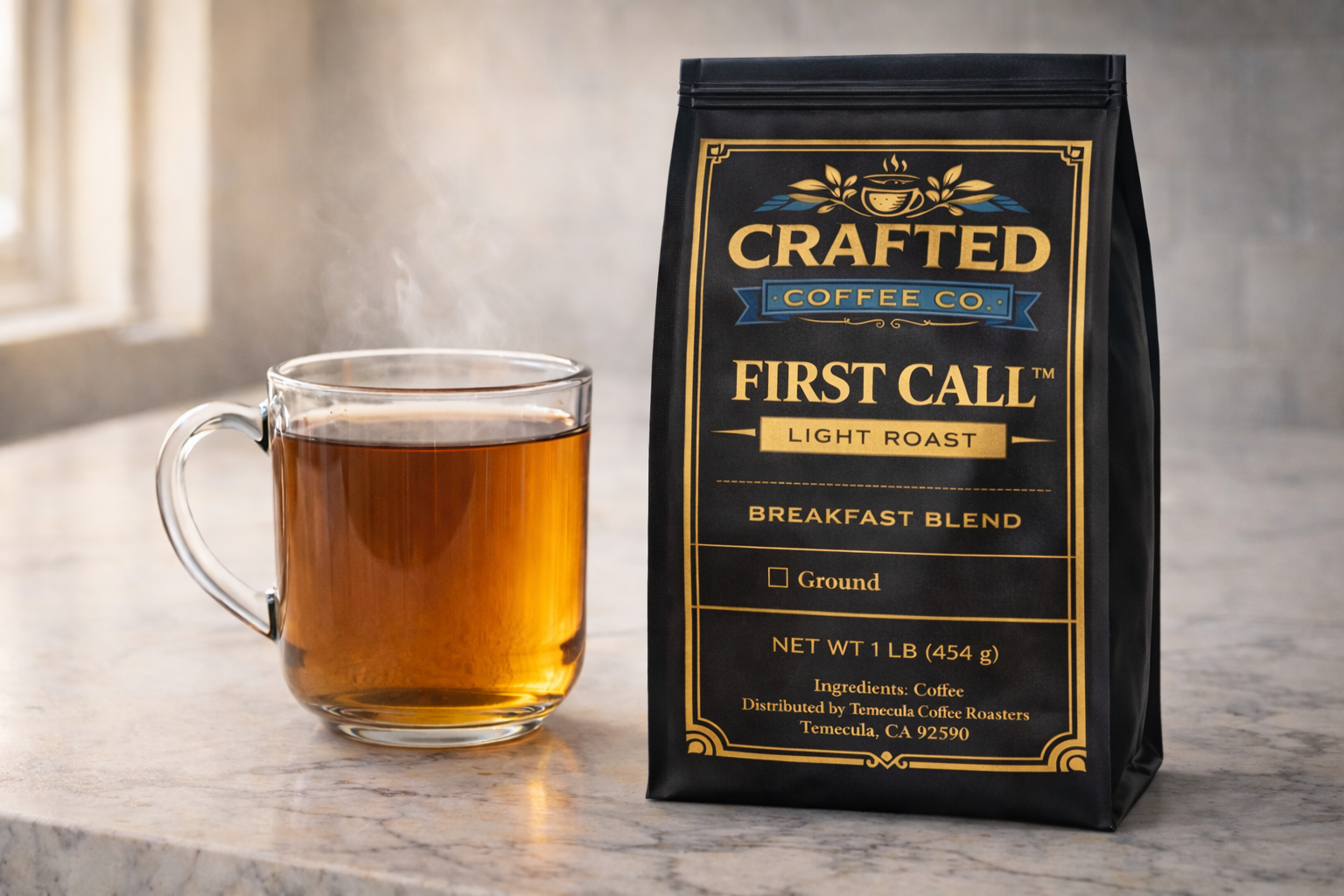 Brewed cup of First Call breakfast blend light roast coffee in glass mug next to unopened bag on white marble countertop