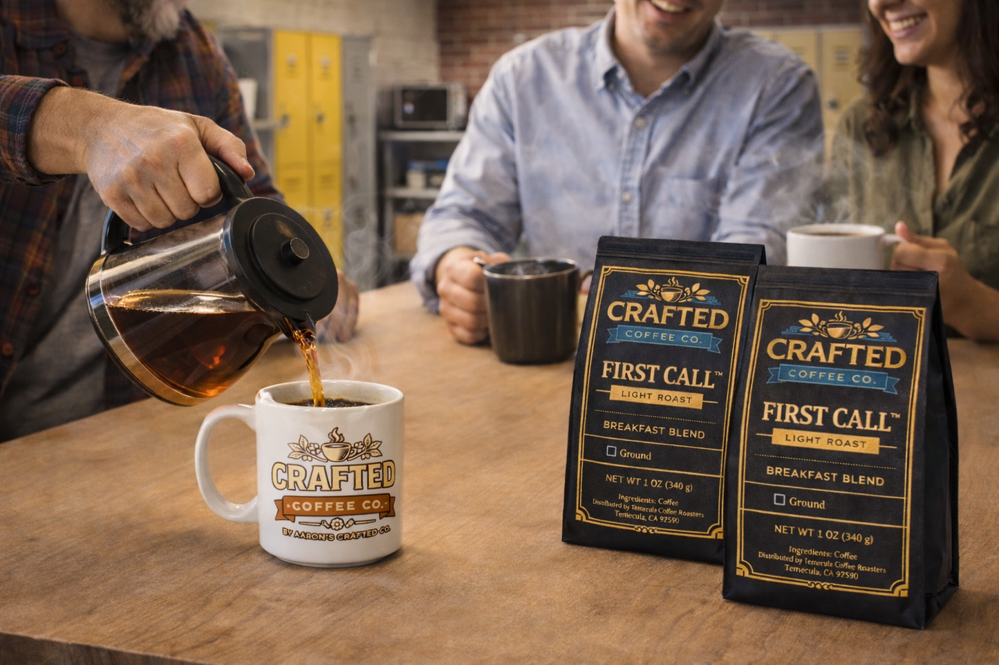 Group sharing First Call breakfast blend light roast coffee from carafe in break room with bags on table
